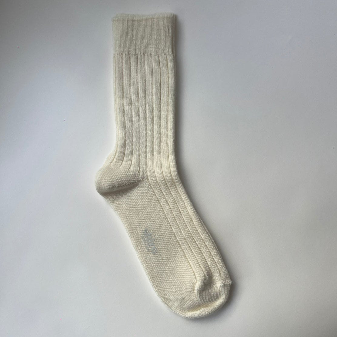 A pair of cream, ribbed, thickly knit merino socks. Made in Italy