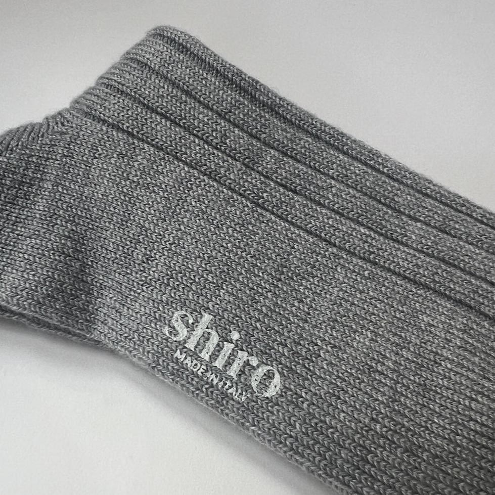 A pair of heather grey, ribbed, thickly knit merino socks. Made in Italy.