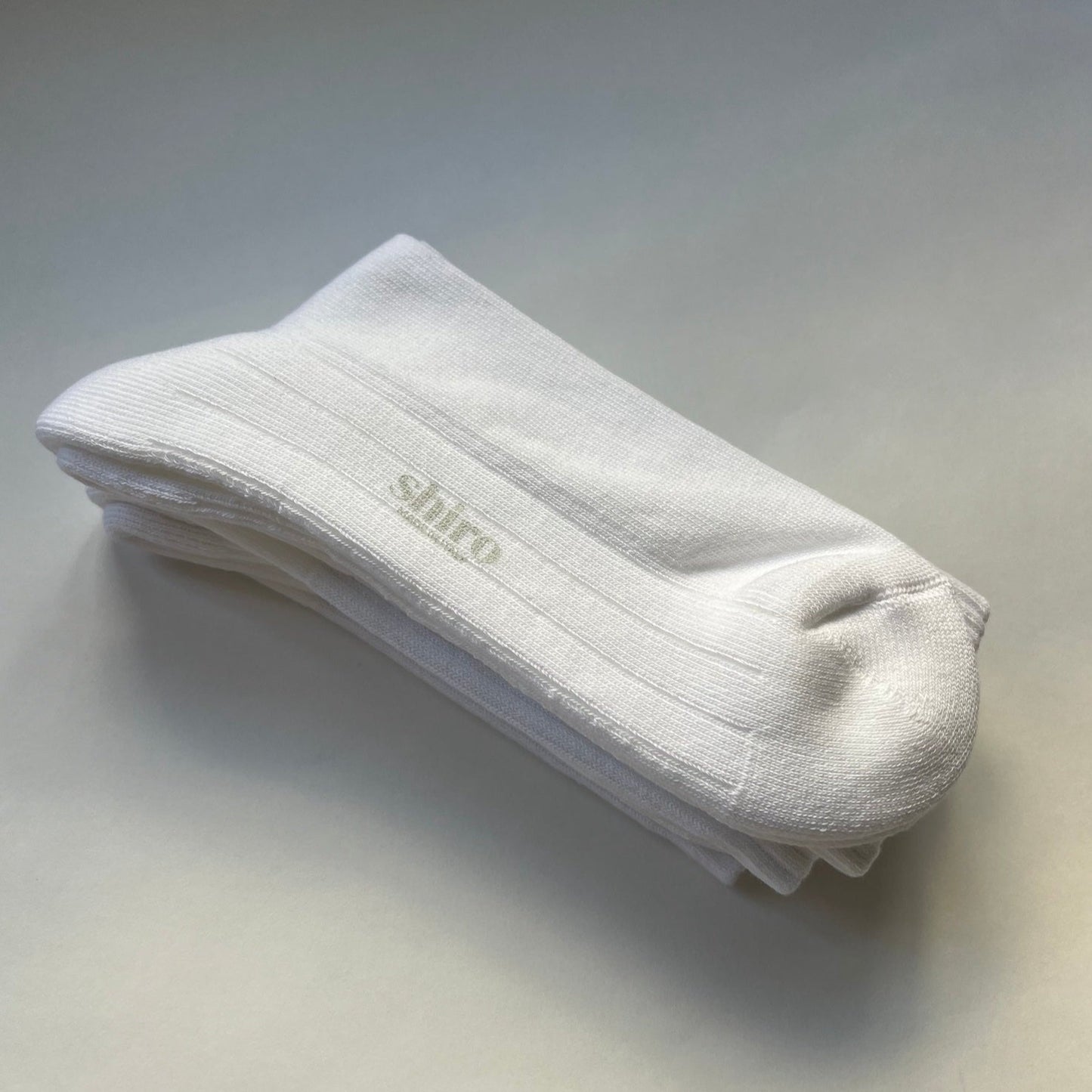 A pair of white, ribbed, lightweight organic egyptian cotton gym socks.  Made in Italy.