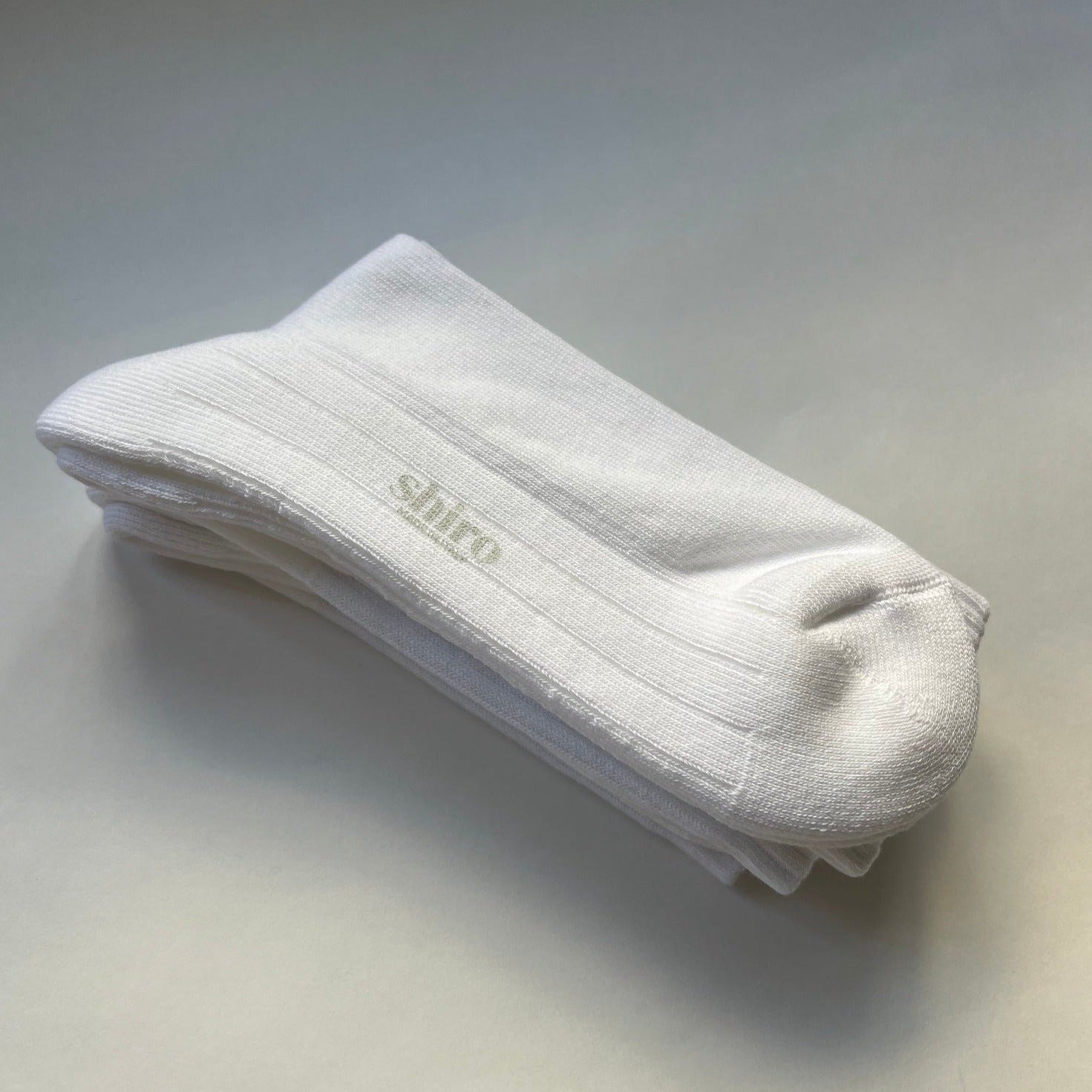 A pair of white, ribbed, lightweight organic egyptian cotton gym socks.  Made in Italy.