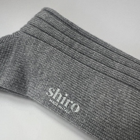 A pair of heather grey, ribbed, thickly knit merino socks.  Made in Italy.