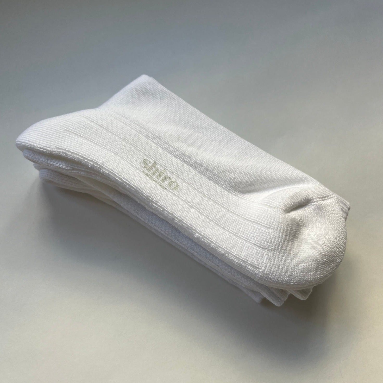 A pair of white, ribbed, lightweight organic egyptian cotton gym socks.  Made in Italy.